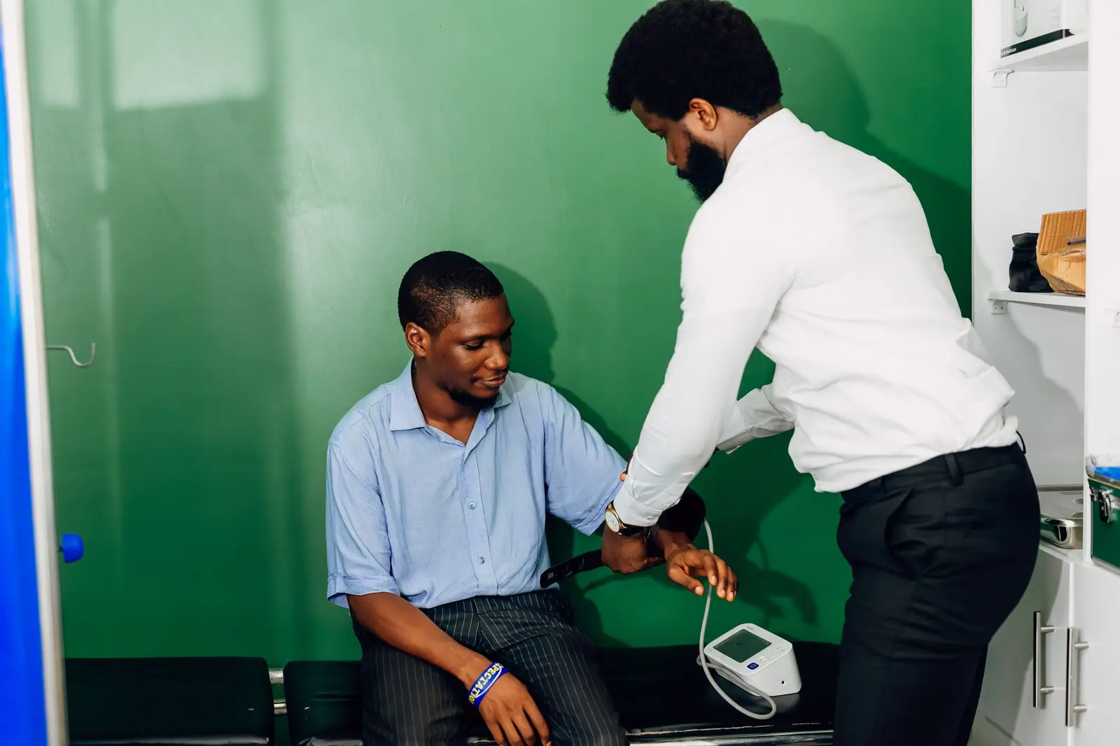 Doctor checking a patient’s blood pressure during a consultation
